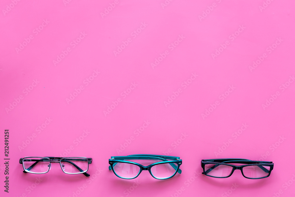 Glasses concept. Set of glasses with different eyeglass frame and transparent lenses on pink background top view copy space pattern Glasses concept. Set of glasses with different eyeglass frame and transparent lenses on pink background top view copy space pattern