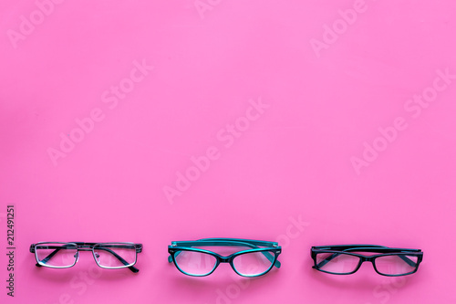 Glasses concept. Set of glasses with different eyeglass frame and transparent lenses on pink background top view copy space pattern