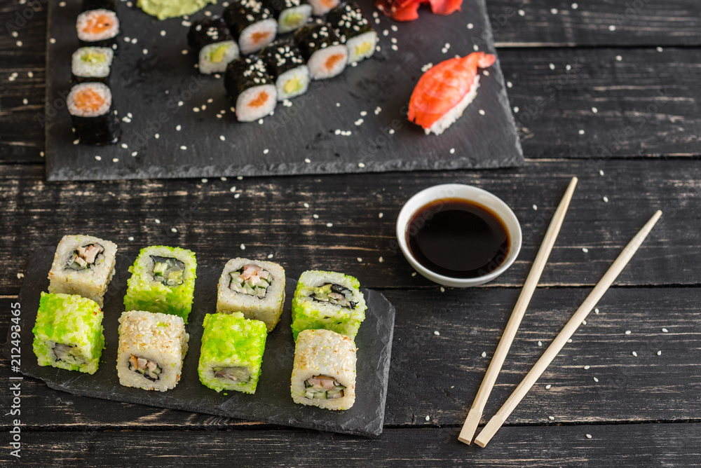Fresh and tasty sushi on dark background. It can be used as a background Fresh and tasty sushi on dark background. It can be used as a background
