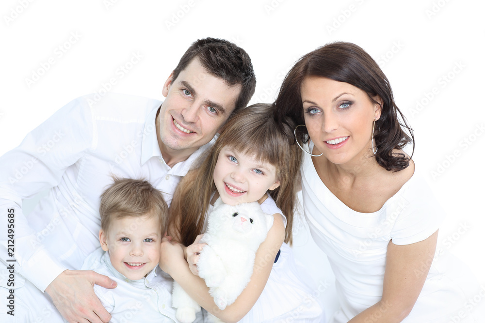 Smiling mother and father holding their children at home
