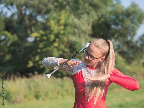 Teen Majorette Girl Twirling Baton Outdoors