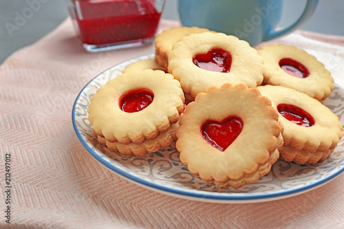Traditional Christmas Linzer cookies with sweet jam on plate