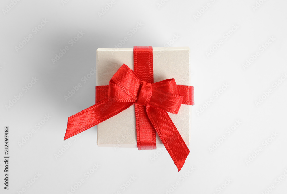 Beautifully wrapped gift box on white background, top view Beautifully wrapped gift box on white background, top view