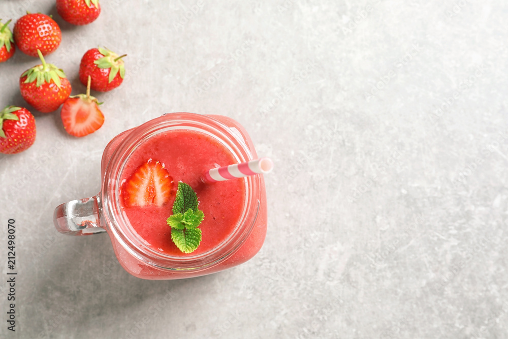 Mason jar with tasty strawberry smoothie on table, top view Mason jar with tasty strawberry smoothie on table, top view