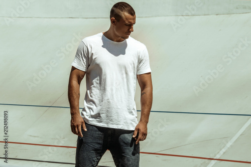 Stripped masculine male model street workout on a stadium photo