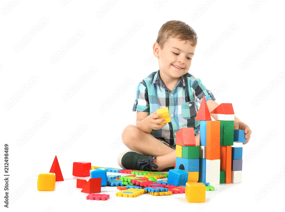 Little child playing with blocks on white background. Indoor recreation Little child playing with blocks on white background. Indoor recreation