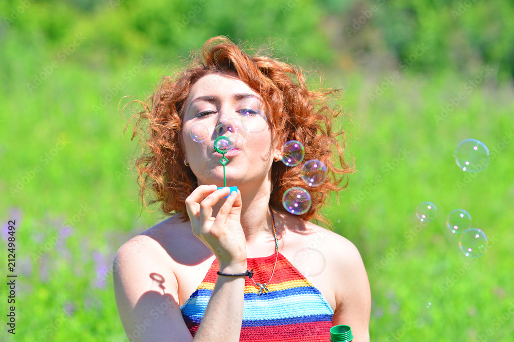 Funny redhead girl blows bubbles Funny redhead girl blows bubbles