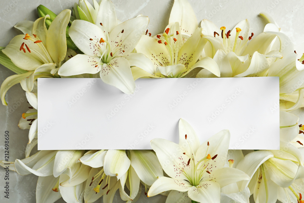 Beautiful lily flowers and blank card, top view - obrazy, fototapety, plakaty 