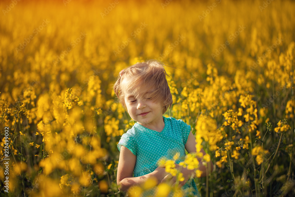 Cute portrait little child on yellow field in sunny summer day Cute portrait little child on yellow field in sunny summer day