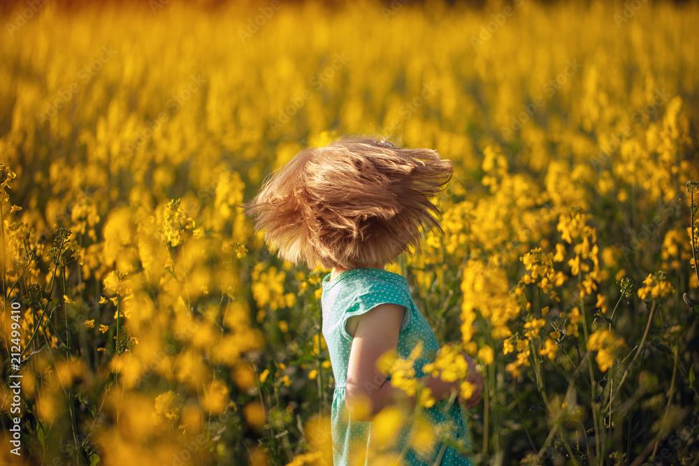 Cute portrait little child on yellow field in sunny summer day Cute portrait little child on yellow field in sunny summer day