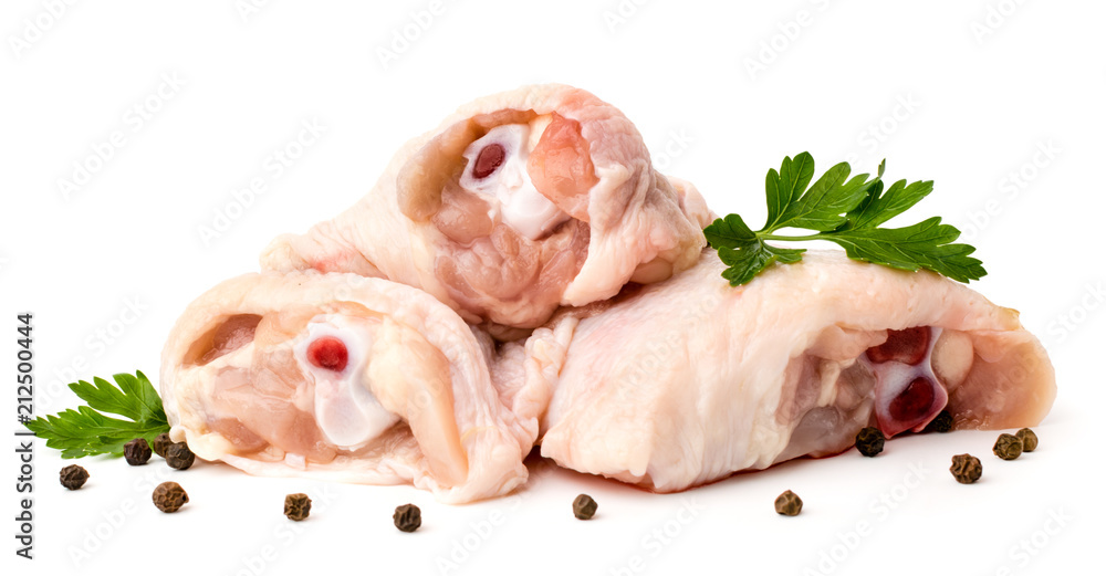 Raw chicken Shin with parsley leaves and black pepper with peas on white background, close-up. Raw chicken Shin with parsley leaves and black pepper with peas on white background, close-up.