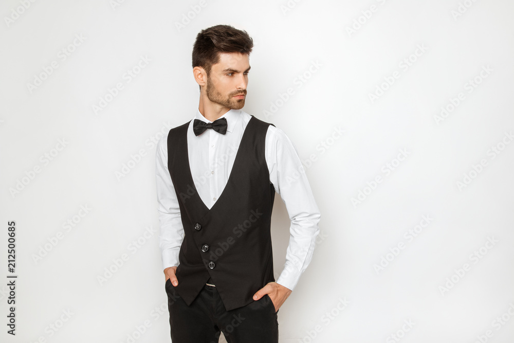 Strong commercial male model face in tuxedo on white background Strong commercial male model face in tuxedo on white background