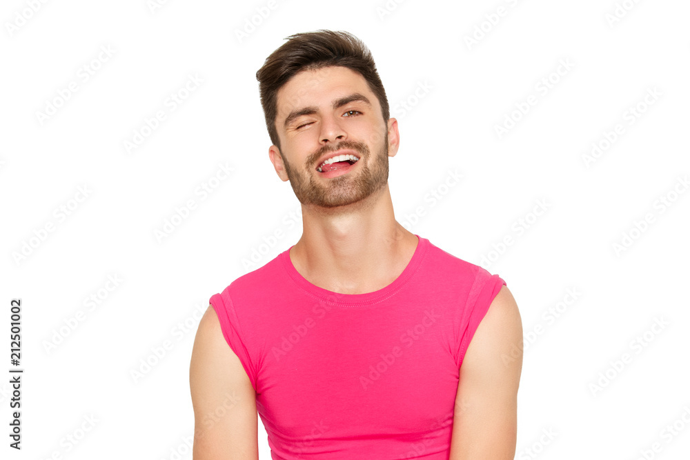 Funny emotional sexy male model in a pink t-shirt on white background Funny emotional sexy male model in a pink t-shirt on white background
