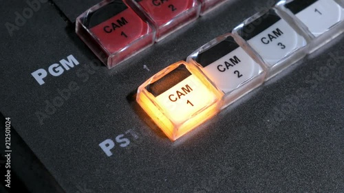 hand of film director is touching key on a control panel during tv shooting