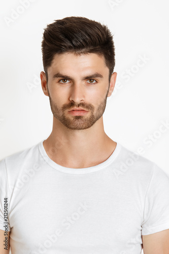 Strong face male model in casual style in white t sirt and jeans on white background