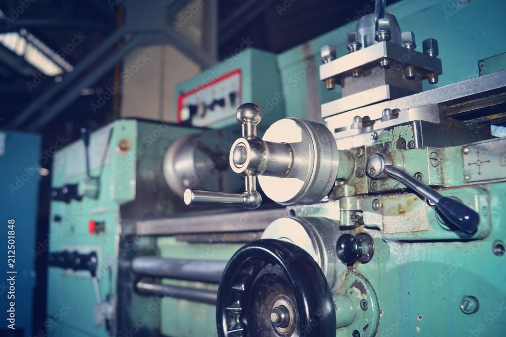 Lathe, metal processing by cutting on industrial equipment. Tinted image.