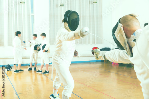Adult fencer practicing lunge with foil