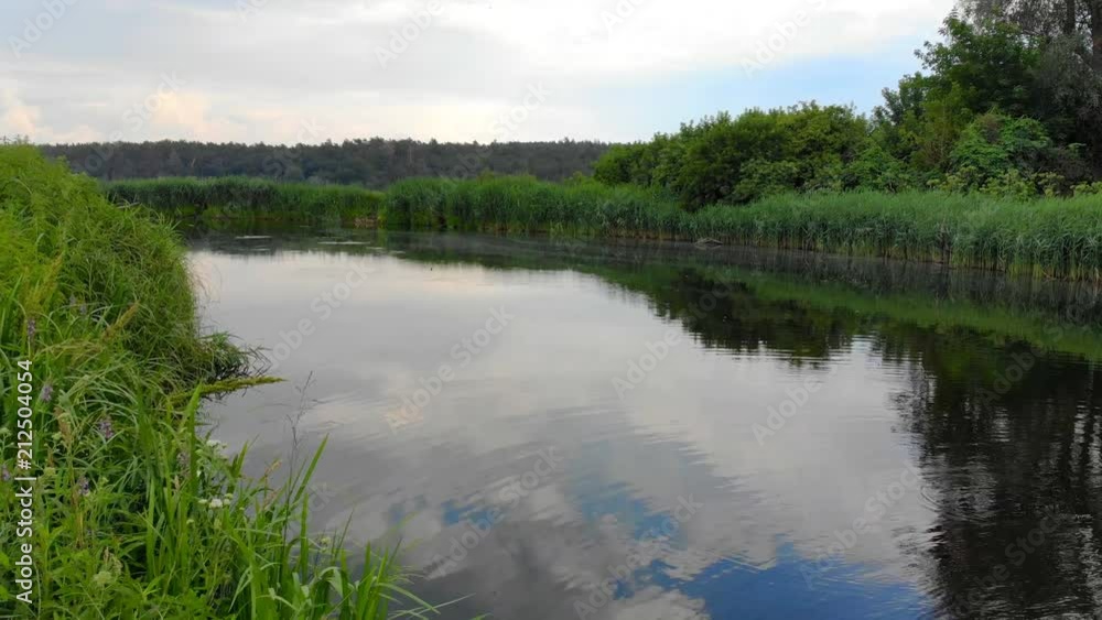 Aerial view of the river, movement along the bends and water surface and the reflection of the sun and sky in the mirror surface of the river Aerial view of the river, movement along the bends and water surface and the reflection of the sun and sky in the mirror surface of the river