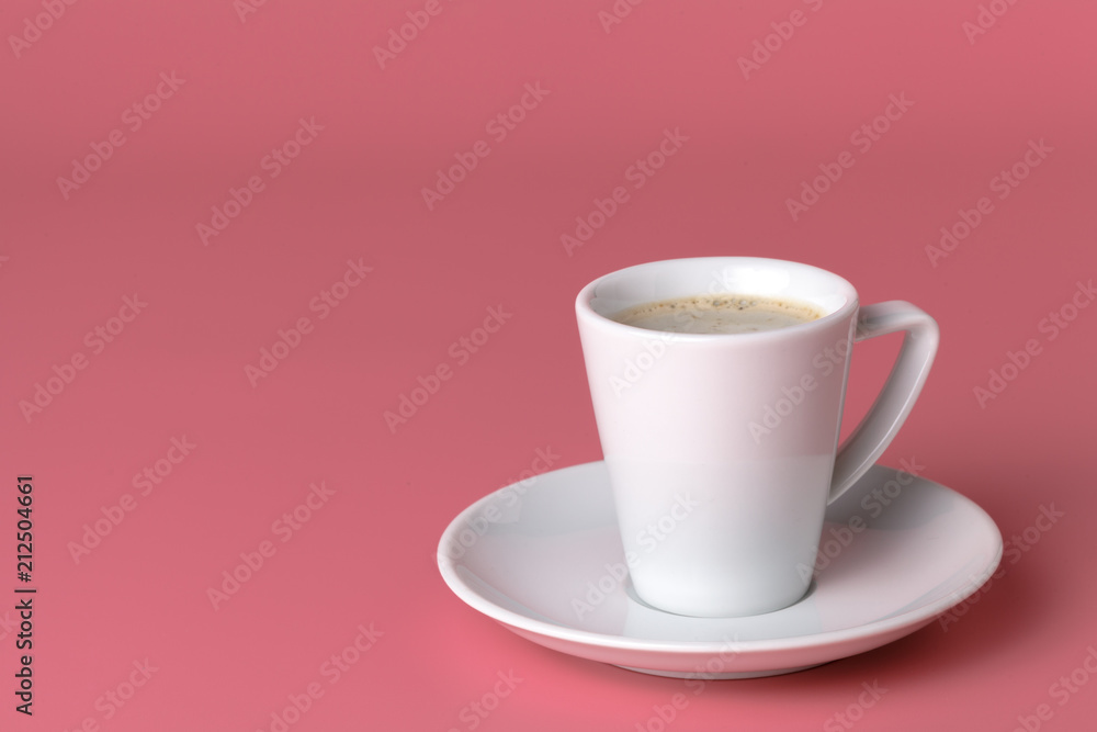 One small cup of coffee on pink background One small cup of coffee on pink background