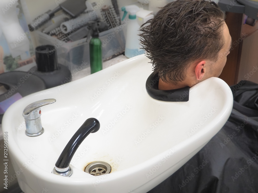 Hair salon hair wash basin. Preparation for washing the head of a man.  Stock Photo | Adobe Stock