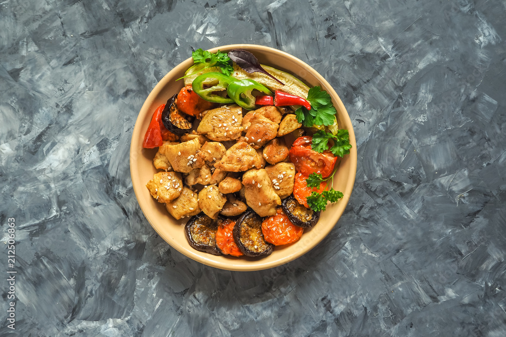 Fototapeta premium Pieces of baked meat with grilled vegetables on a plate.
