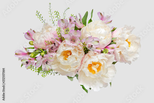Bouquet with light pink peonies and alstroemerias on a light background