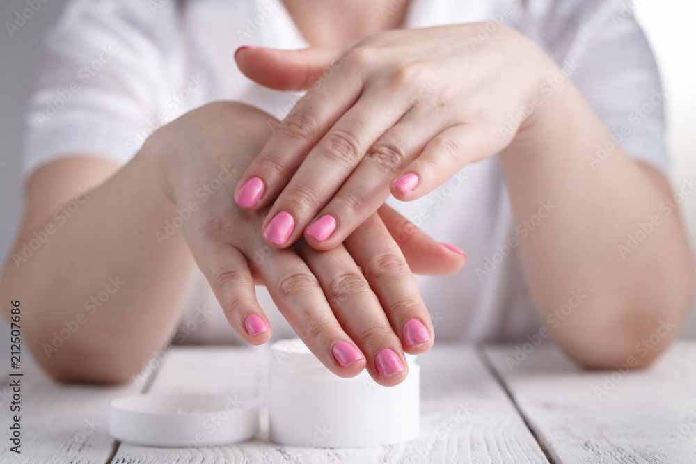 Woman applying hand cream Woman applying hand cream