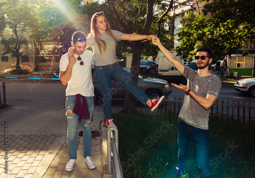 GROUP OF THREE CAREFREE FRIEND TAKE A LEISURELY WALK. Young and careless concept.