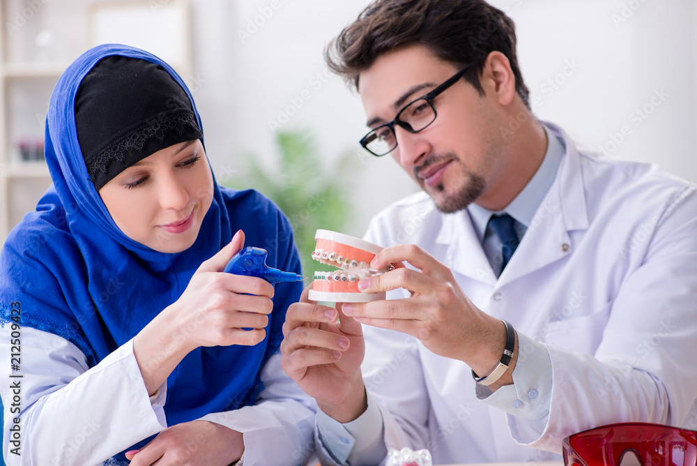 Dentist doctor and assistant working on new tooth implant Dentist doctor and assistant working on new tooth implant