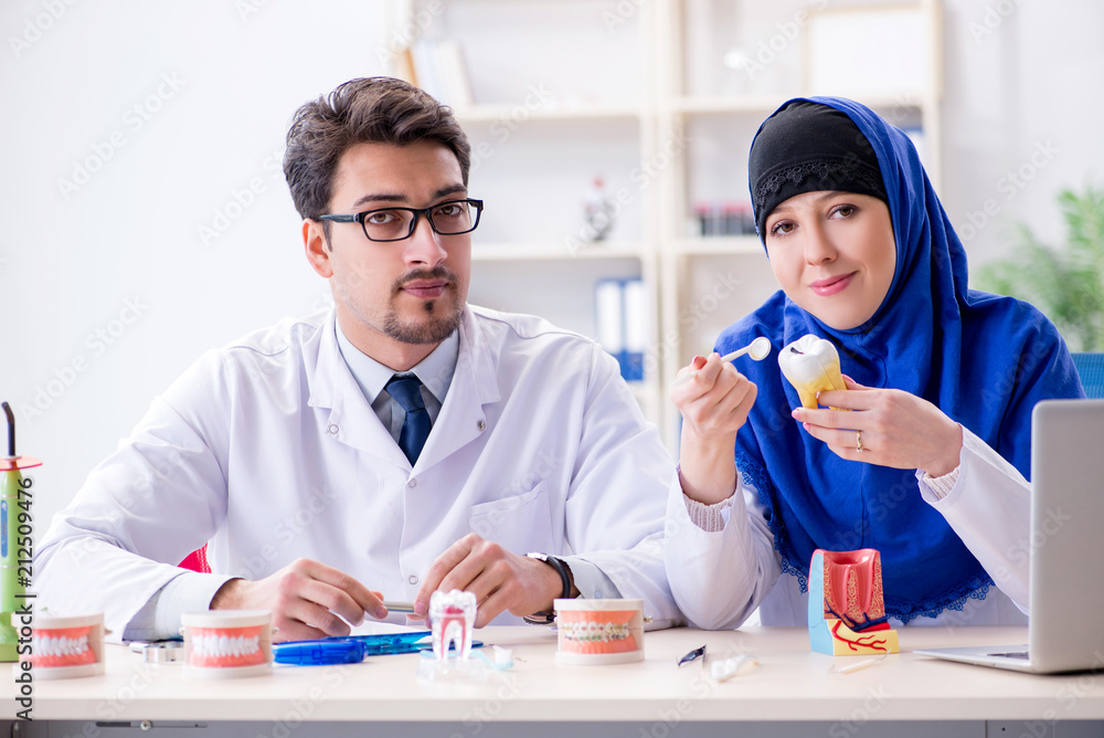 Dentist doctor and assistant working on new tooth implant Dentist doctor and assistant working on new tooth implant