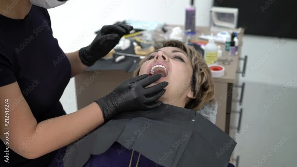 Patient in dental clinic on chair with veneers Patient in dental clinic on chair with veneers