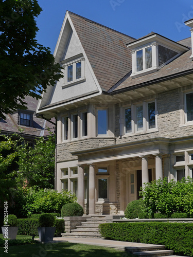 modern stone house with gable and dormer window