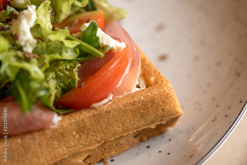 Homemade Belgian Waffle with salad Iceberg, tomatoes and ham Homemade Belgian Waffle with salad Iceberg, tomatoes and ham