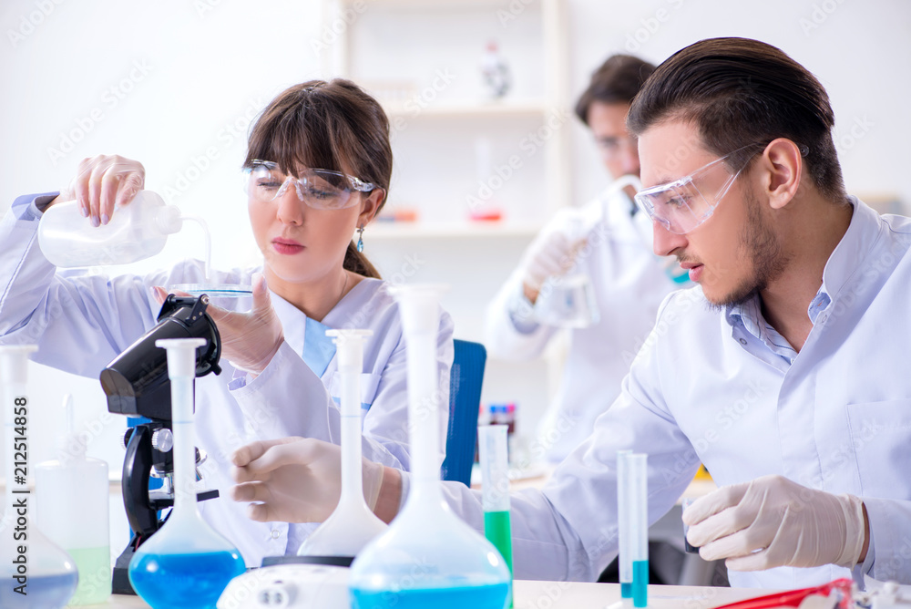 Team of chemists working in the lab Team of chemists working in the lab