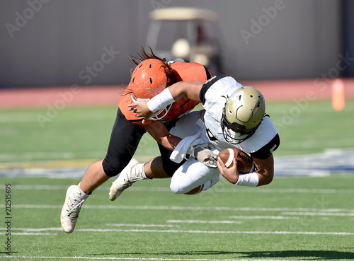 Football player making a tackle during a game