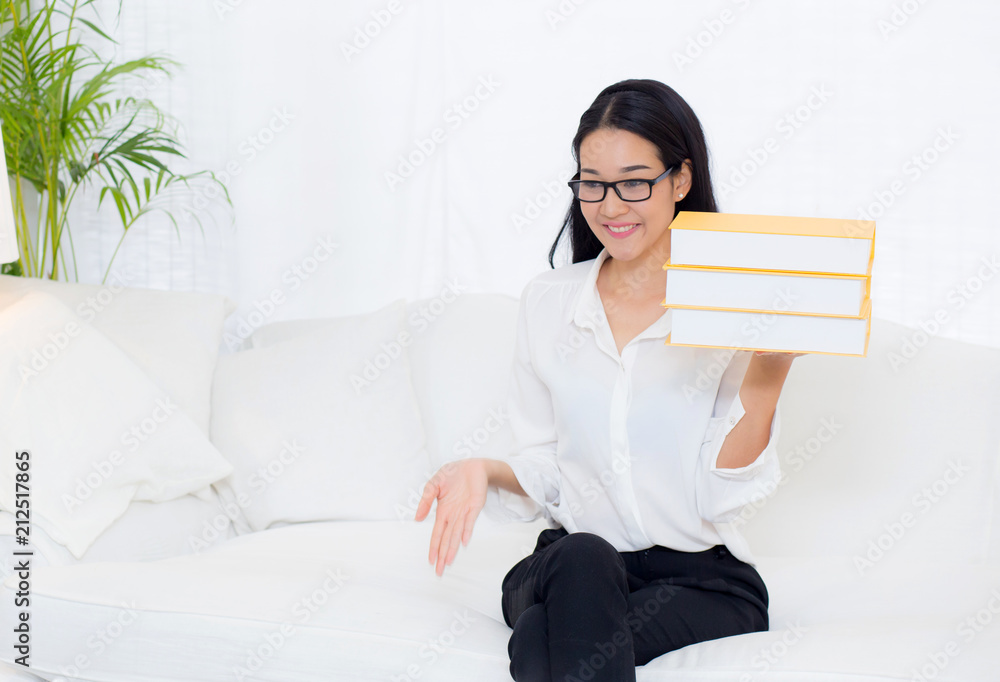 portrait of a beautiful young asian woman read book on couch in living room - education concept. portrait of a beautiful young asian woman read book on couch in living room - education concept.