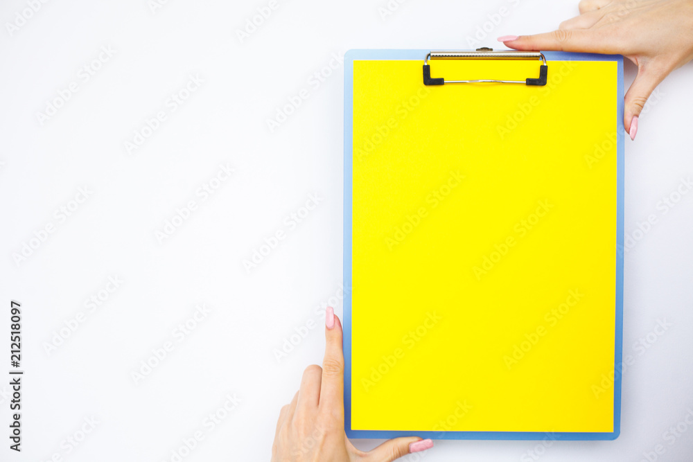 Blank Folder with Yellow Paper. Hand that Holding Folder and Handle on White Background. Copyspace. Place for Text. Blank Folder with Yellow Paper. Hand that Holding Folder and Handle on White Background. Copyspace. Place for Text.