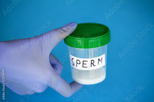 Health. Sperm Analysis. Concept of Bank Sperm. Infertility. Doctor's Hand Holding Container for Analyzes photo