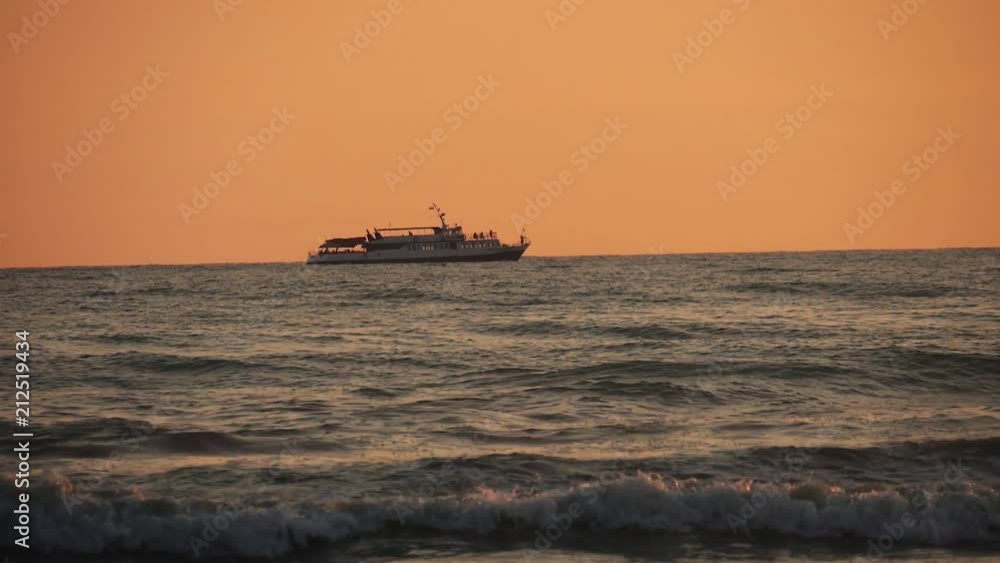 Ship silhouette in rough seas on sunset background. Ship silhouette in rough seas on sunset background.