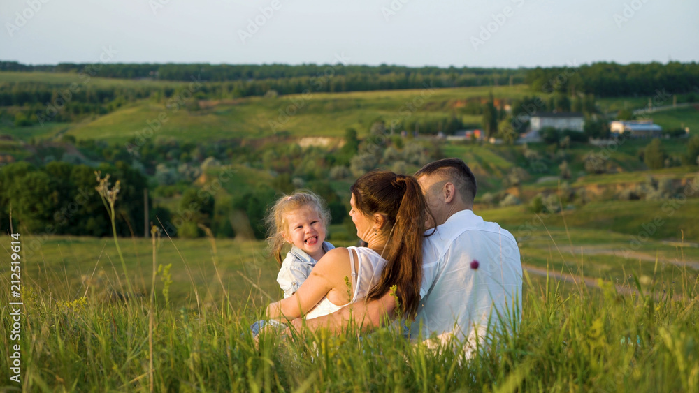 Pregnant couple with toddler daughter have leisure time outdoors back view. Happy young parents expecting baby with child at sunset. Parenthood, pregnancy, childhood, healthy, activity concept Pregnant couple with toddler daughter have leisure time outdoors back view. Happy young parents expecting baby with child at sunset. Parenthood, pregnancy, childhood, healthy, activity concept