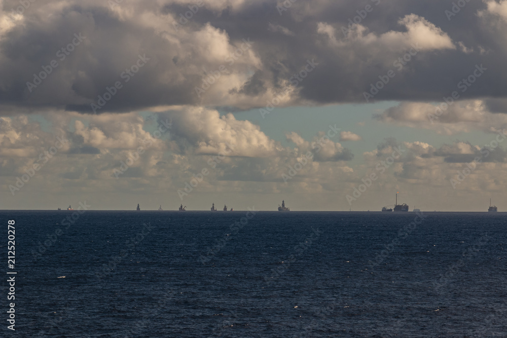 Beautiful day in the oil towers and offshore oil rigs, beautiful clouds, sea and sky, MORE OPTIONS IN MY PORTFOLIO Beautiful day in the oil towers and offshore oil rigs, beautiful clouds, sea and sky, MORE OPTIONS IN MY PORTFOLIO