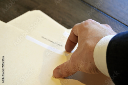 Man Reaching for Folders