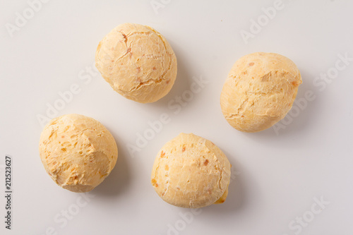 Pao de Queijo is a cheese bread ball from Brazil. Also known as Chipa, Pandebono and Pan de Yuca. Snacks over white background, minimalism. photo