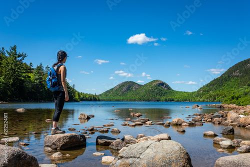 Hiker enjoying the view at Jordan Pond in Acadia National Park