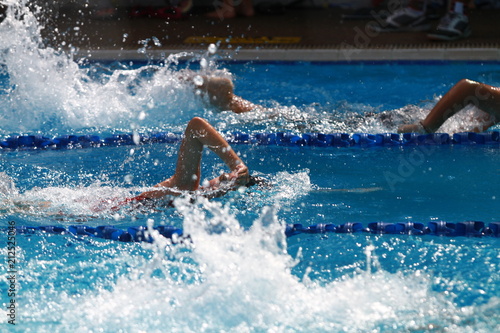 A group of swimmer swimming freestyle, front crawl or australian crawl stroke in a swimming pool for competition or race © wibulpas