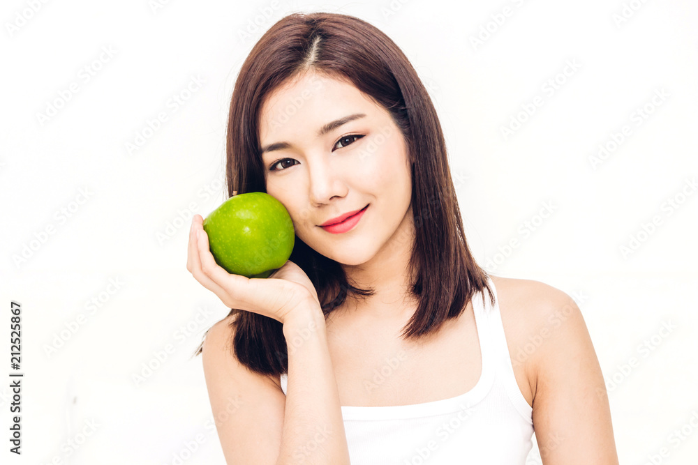 Woman holding and eating fresh green apple on white background.dieting concept.healthy lifestyle Woman holding and eating fresh green apple on white background.dieting concept.healthy lifestyle