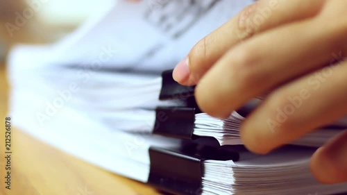 Businessmen are searching for documents lying on the table,business report papers,important documents.