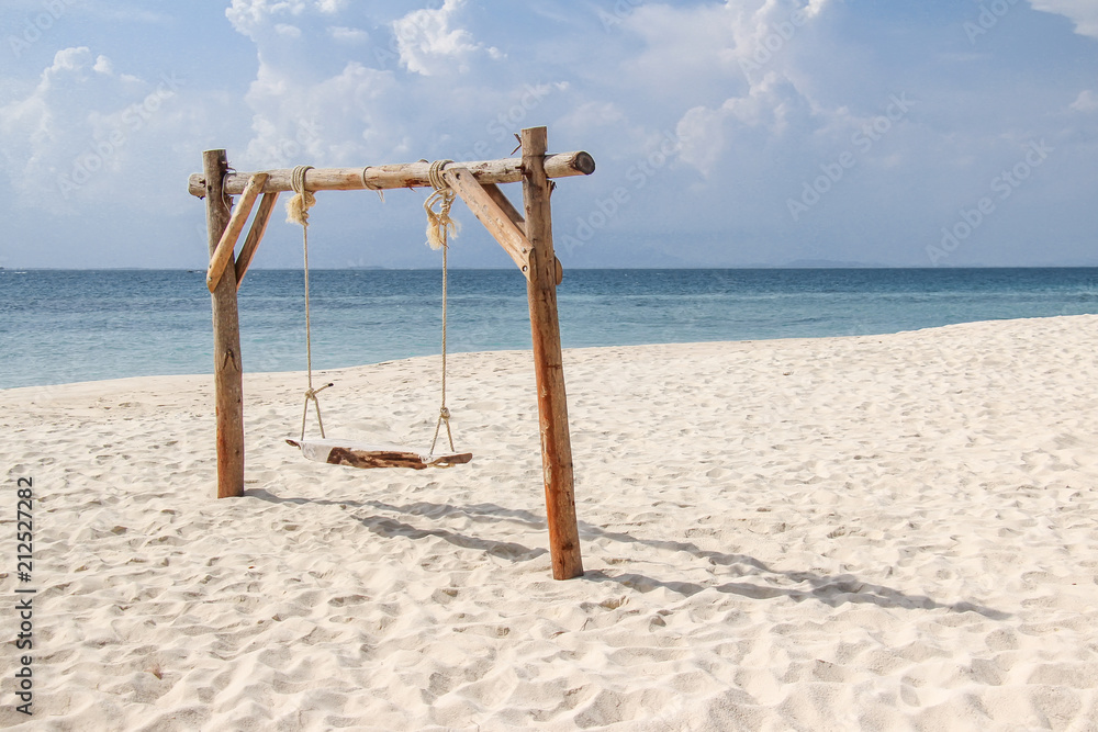 Wooden swing on the sand beach for summer holiday concept. Wooden swing on the sand beach for summer holiday concept.
