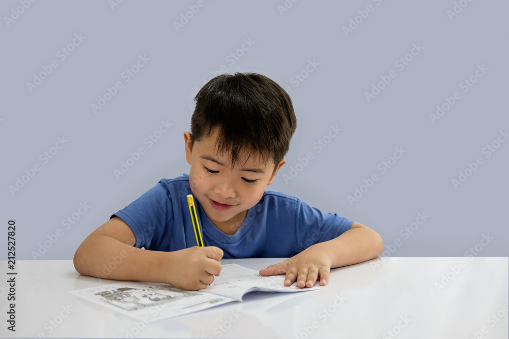 Asian boys are doing some writing on the book. Asian boys are doing some writing on the book.