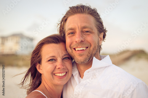 Smiling couple on windy beach